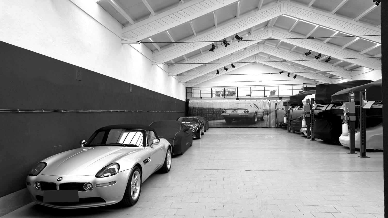 A silver sports car inside the Hangar414 interior